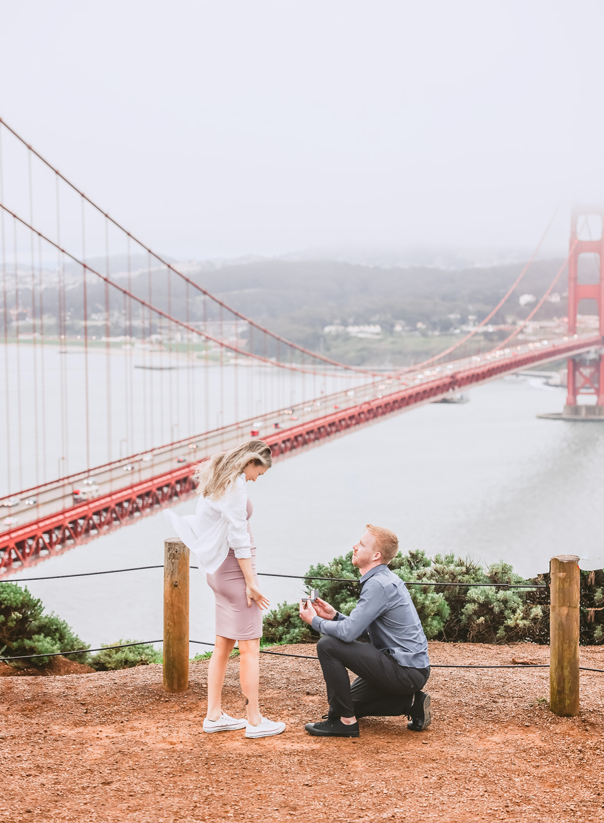 Proposal engagement photography at Battery Spencer with Golden Gate Bridge on a cloudy day in San Francisco