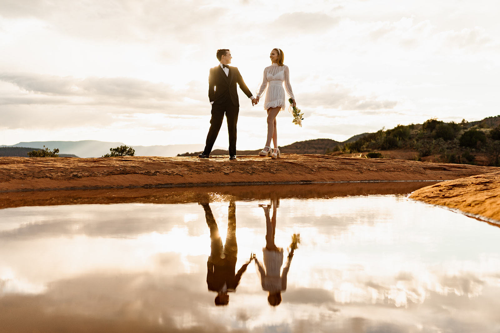 Reflection of elopement couple at best Sedona secret location