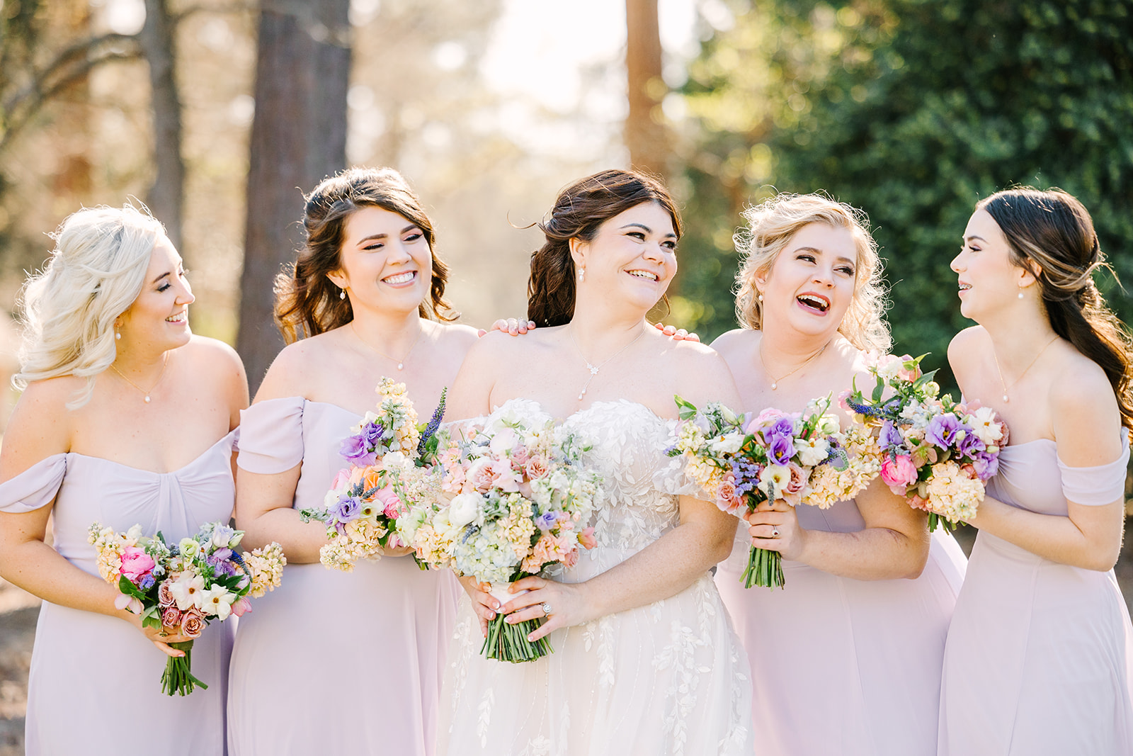 Bride and bridesmaids in lilac dresses at the Oaks at Salem