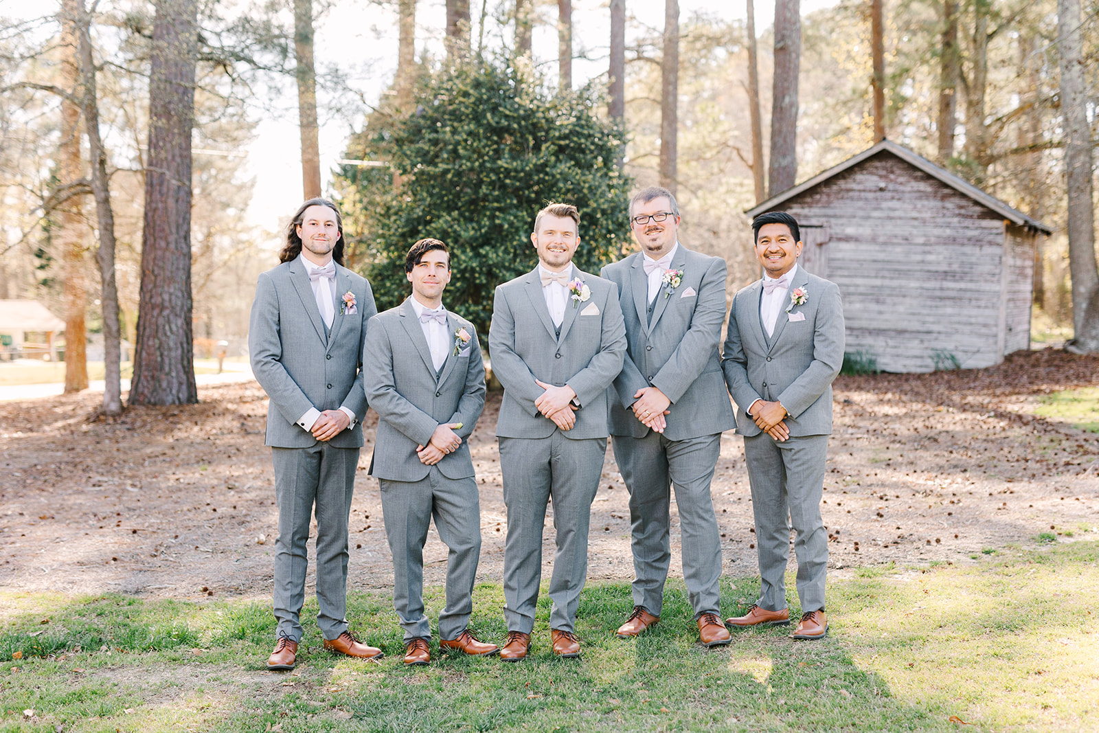 Groom and groomsmen in grey suits at the Oaks at Salem