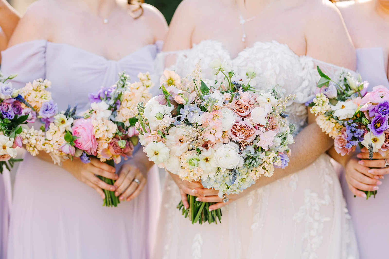 Spring bouquets with peach, pink, and purple flowers for a wedding at the Oaks at Salem