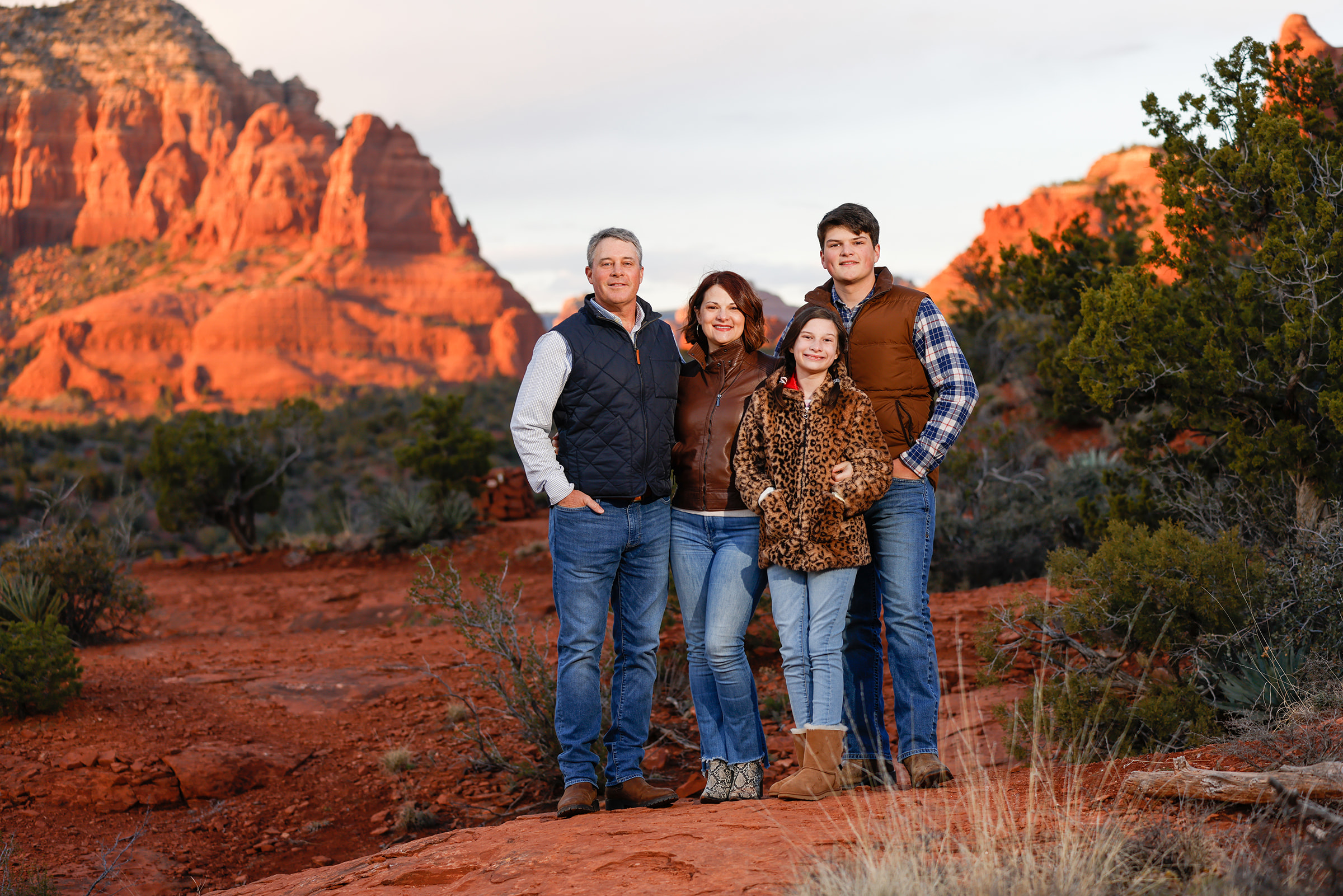 Family of four for a classic Sedona family portrait session in the red rocks with photographer Heather Kadar