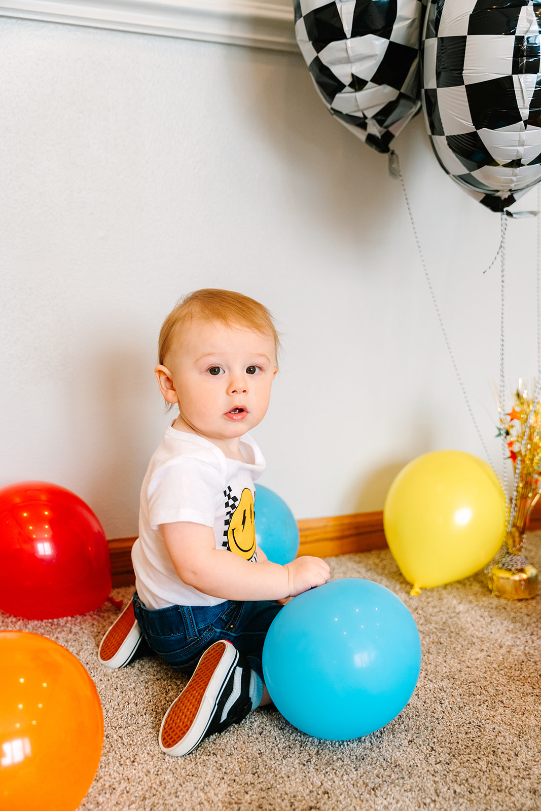 Little boy plays with balloons during a photo shoot