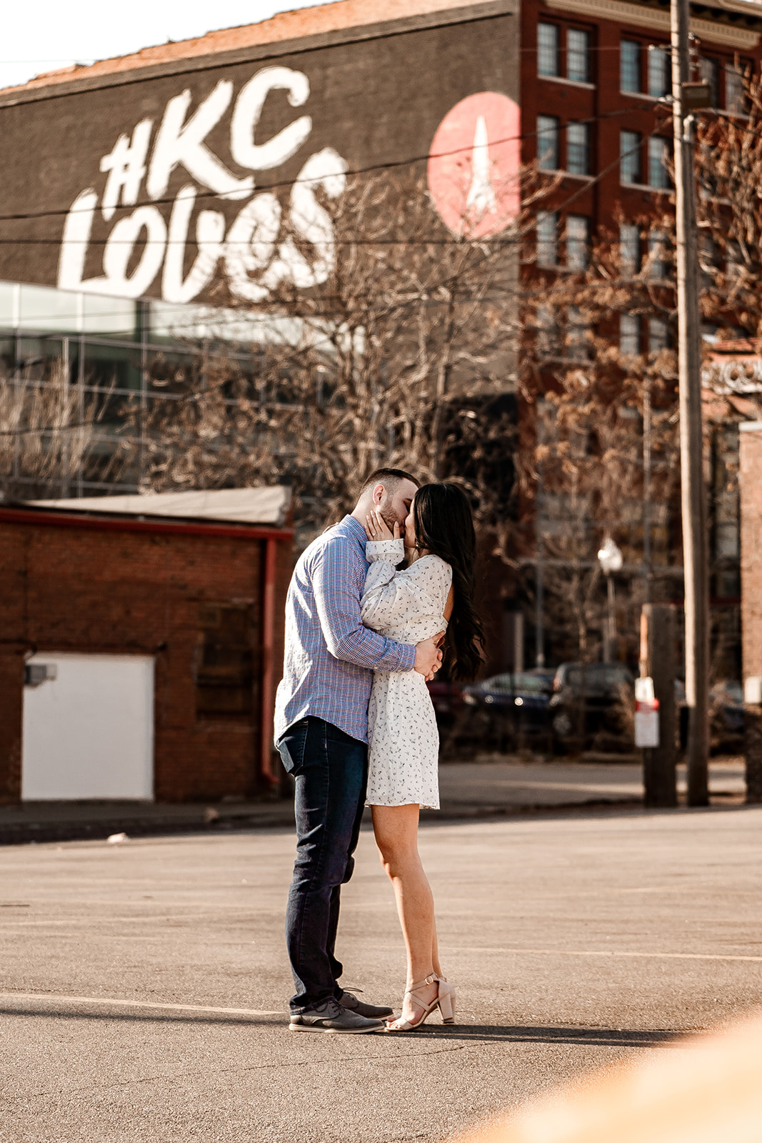 KC Loves graffiti mural engagement photo of couple kissing