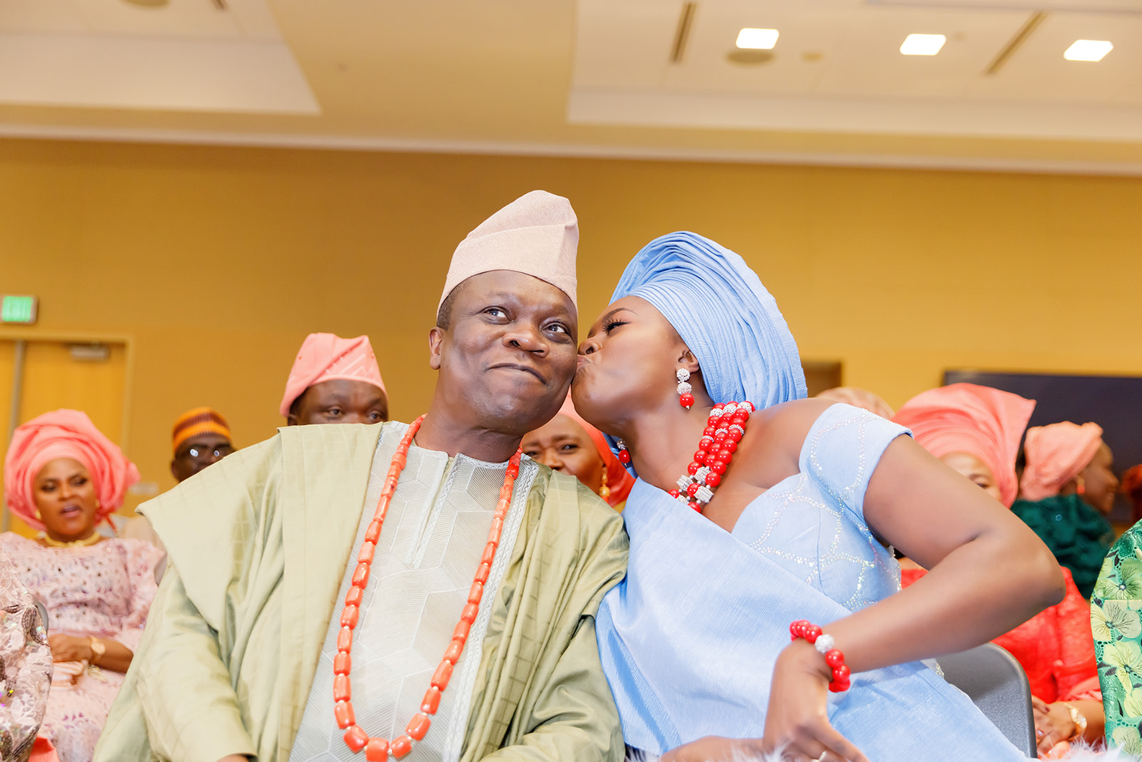 Bride kissing dad during Nigerian and American traditional wedding at Truhlsen Campus Events Center at UNMC
