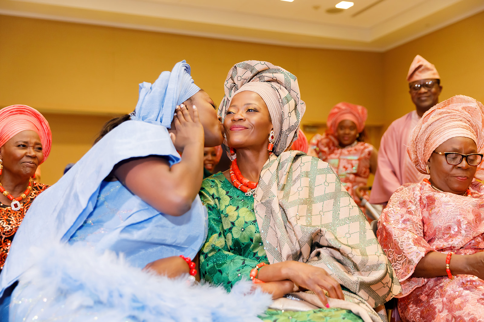 Bride kissing her mom during Nigerian and American traditional wedding at Truhlsen Campus Events Center at UNMC