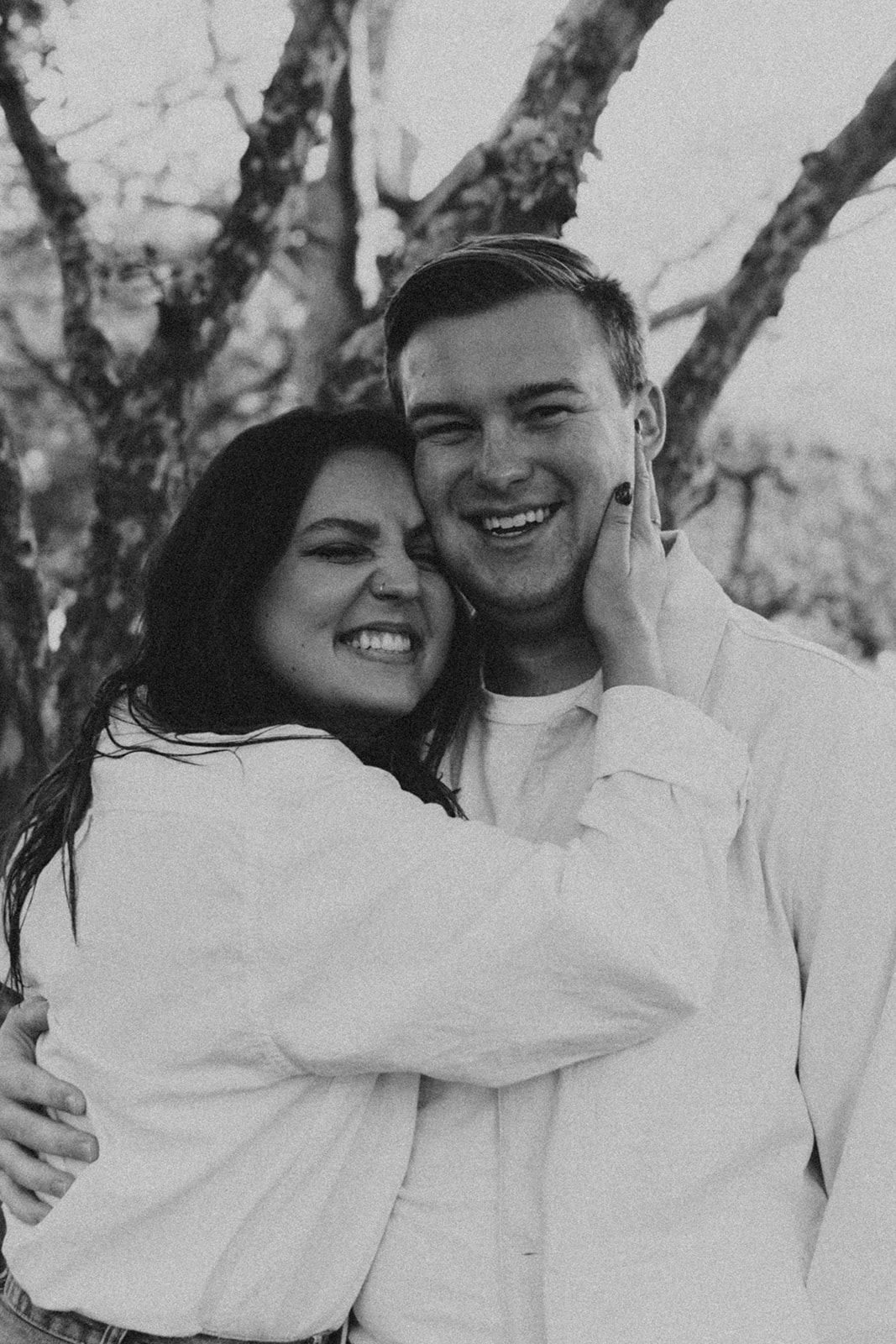 black and white photo of couple squishing their faces together smiling