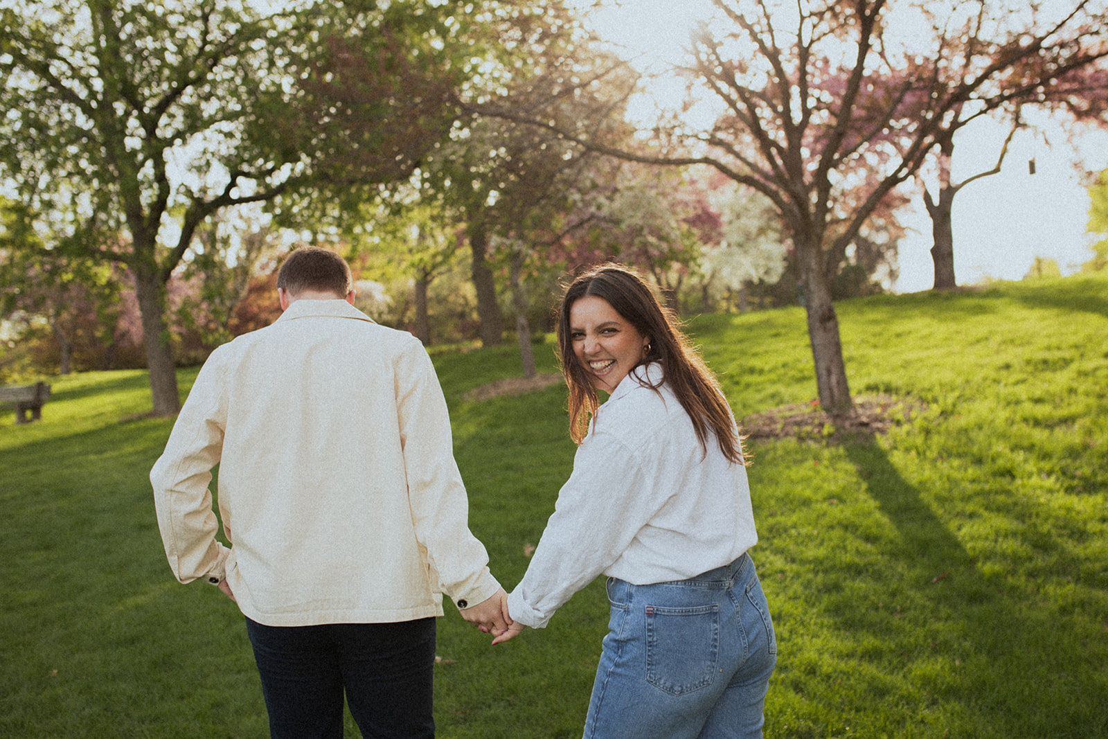 couple walking and laughing together during their sunrise engagement session