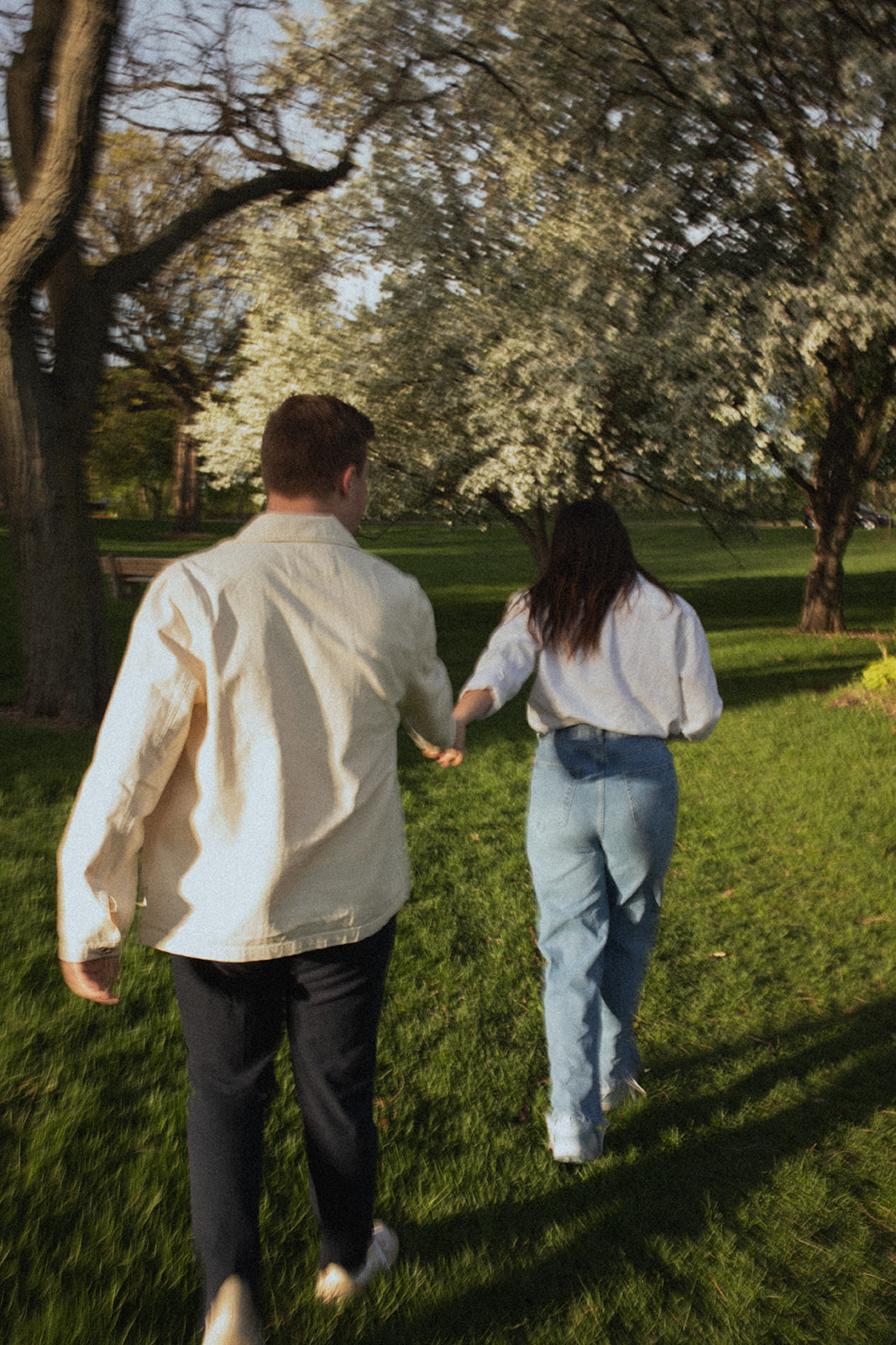 motion blur photo of couple walking together holding hands through Lyndale Rose Garden Minneapolis