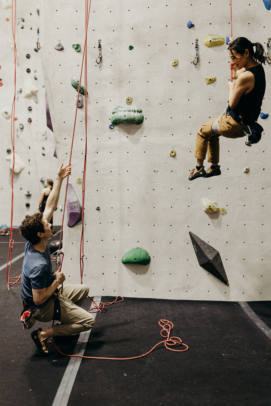 couple bonding at an indoor rock climbing gym