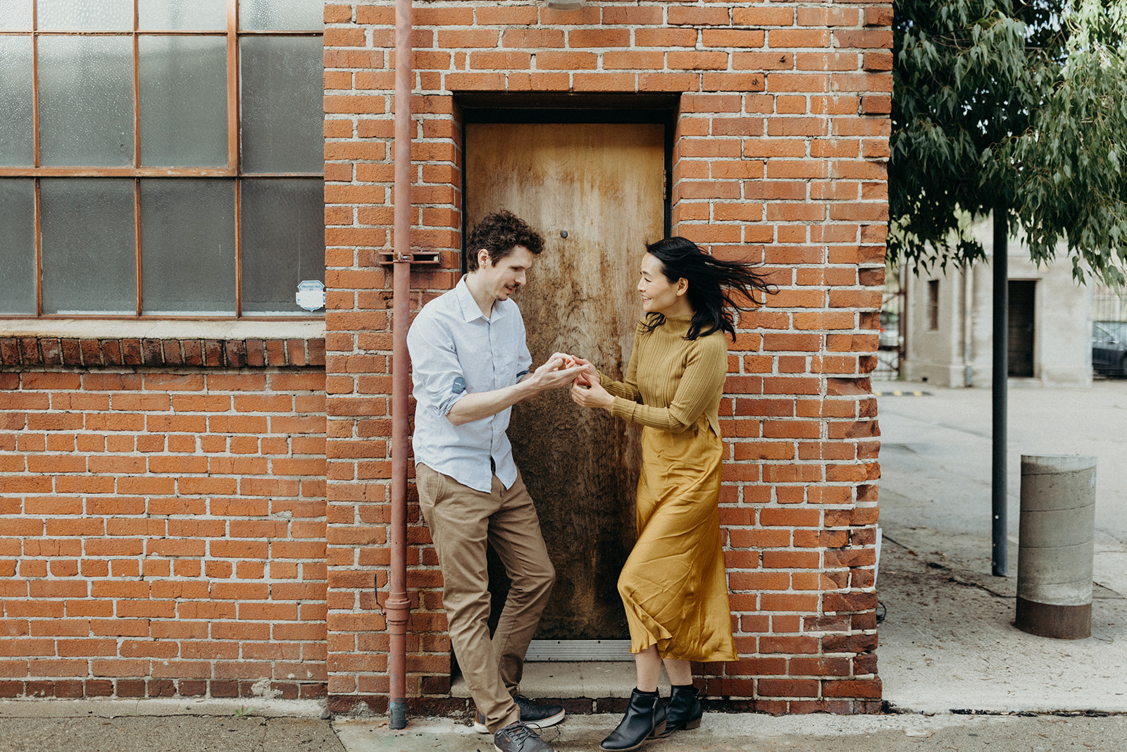 couple in front of brick building in los angeles