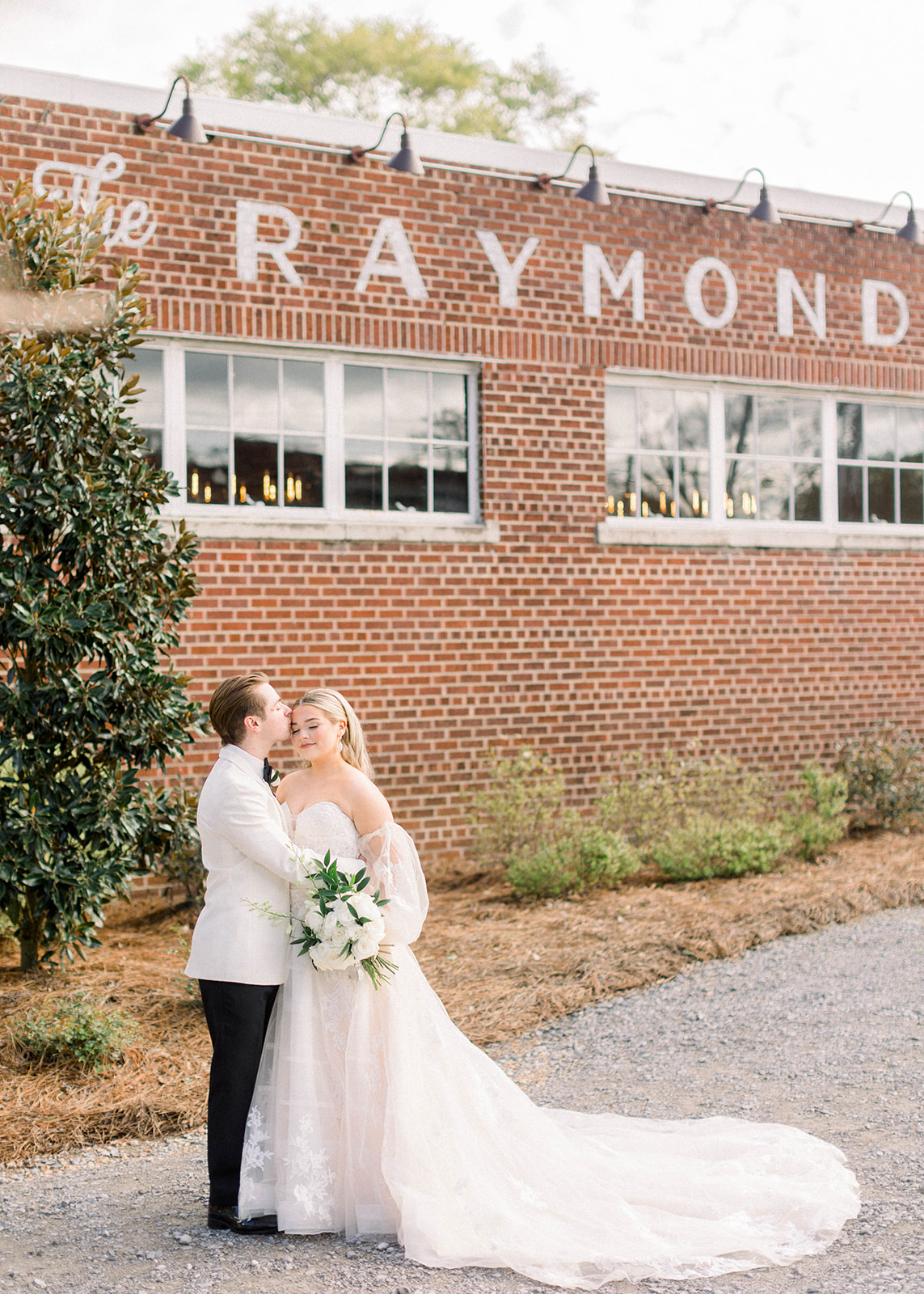 bride and groom smile outside the raymond venue in mississippi