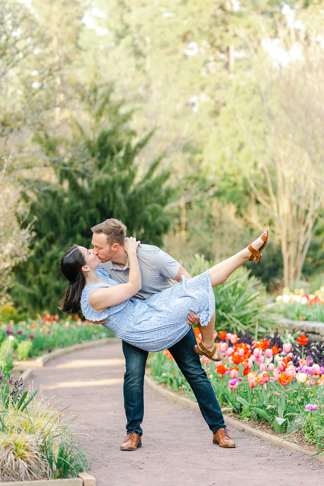 Couple kissing and dipping among the spring tulips at Duke Gardens