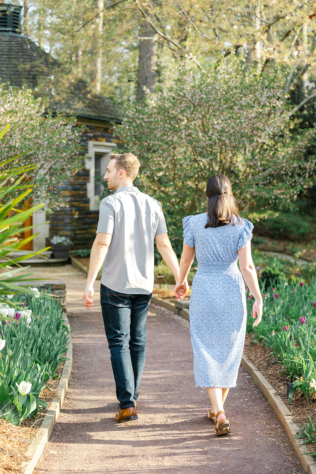 Couple walking through the tulip garden in Duke Gardens