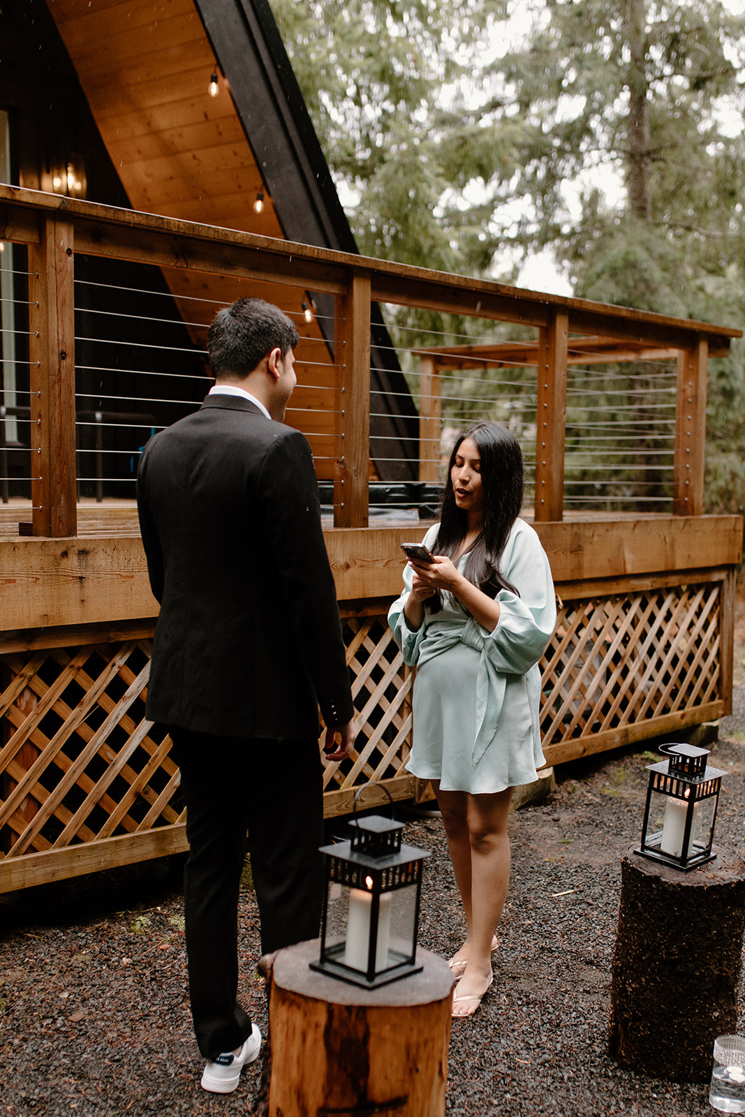 A couple share a ring exchange ceremony at an A-Frame cabin at the base of Mount Rainier to celebrate their engagement.