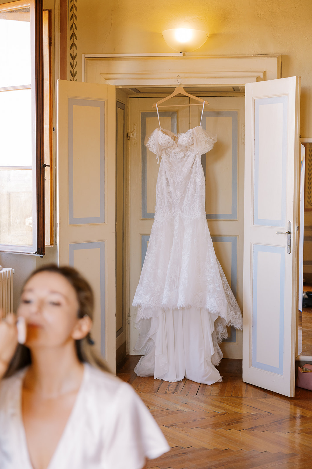 wedding dress hands in doorway behind bride