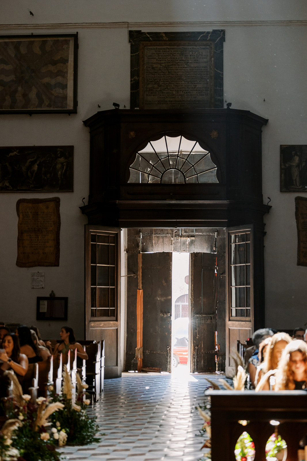 Bride peaks into her ceremony in an Italian church
