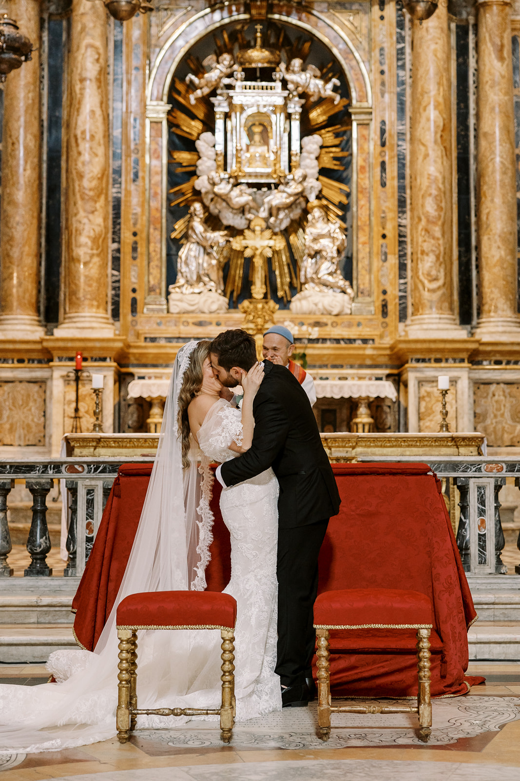 bride and groom kiss in Italian wedding at church