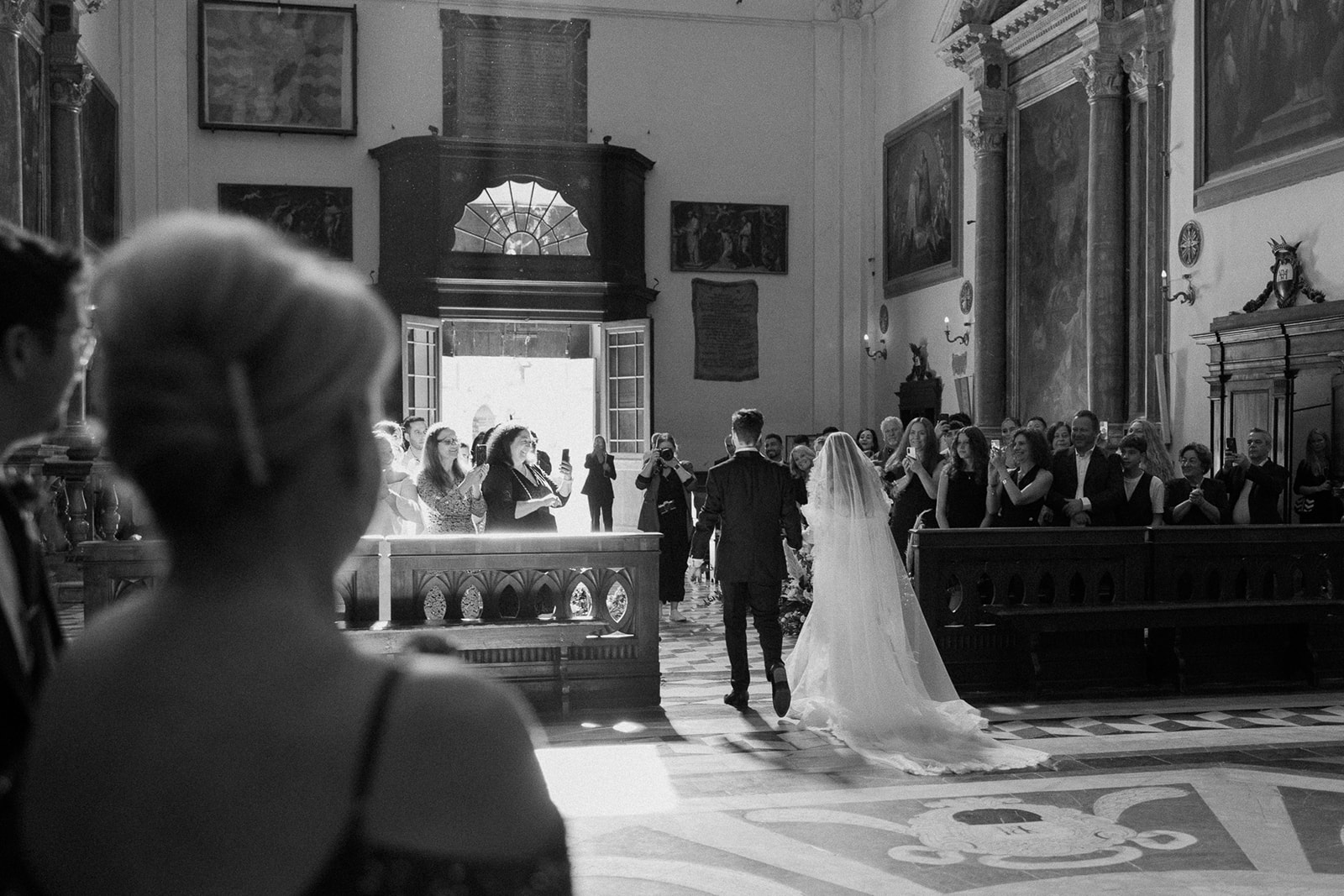 bride and groom walk out of church