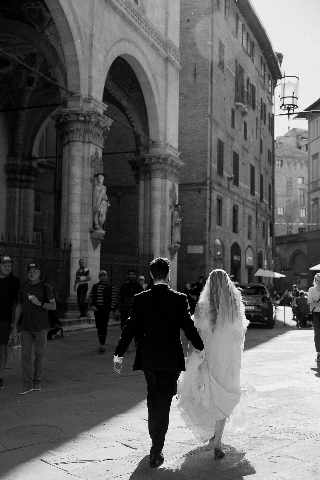 bride and groom walk Italian streets