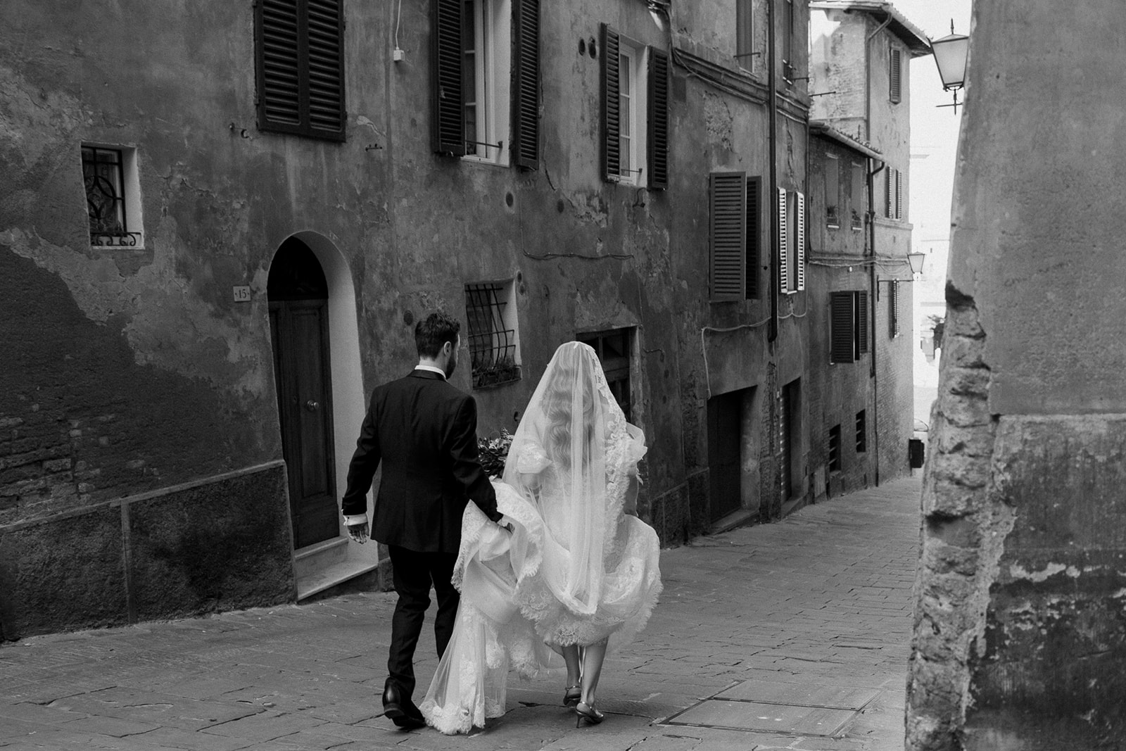 Bride and groom walk Italian streets