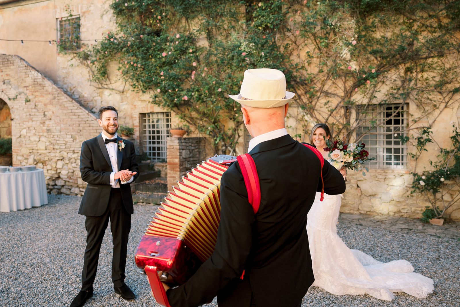 accordion player stands in front of bride and groom