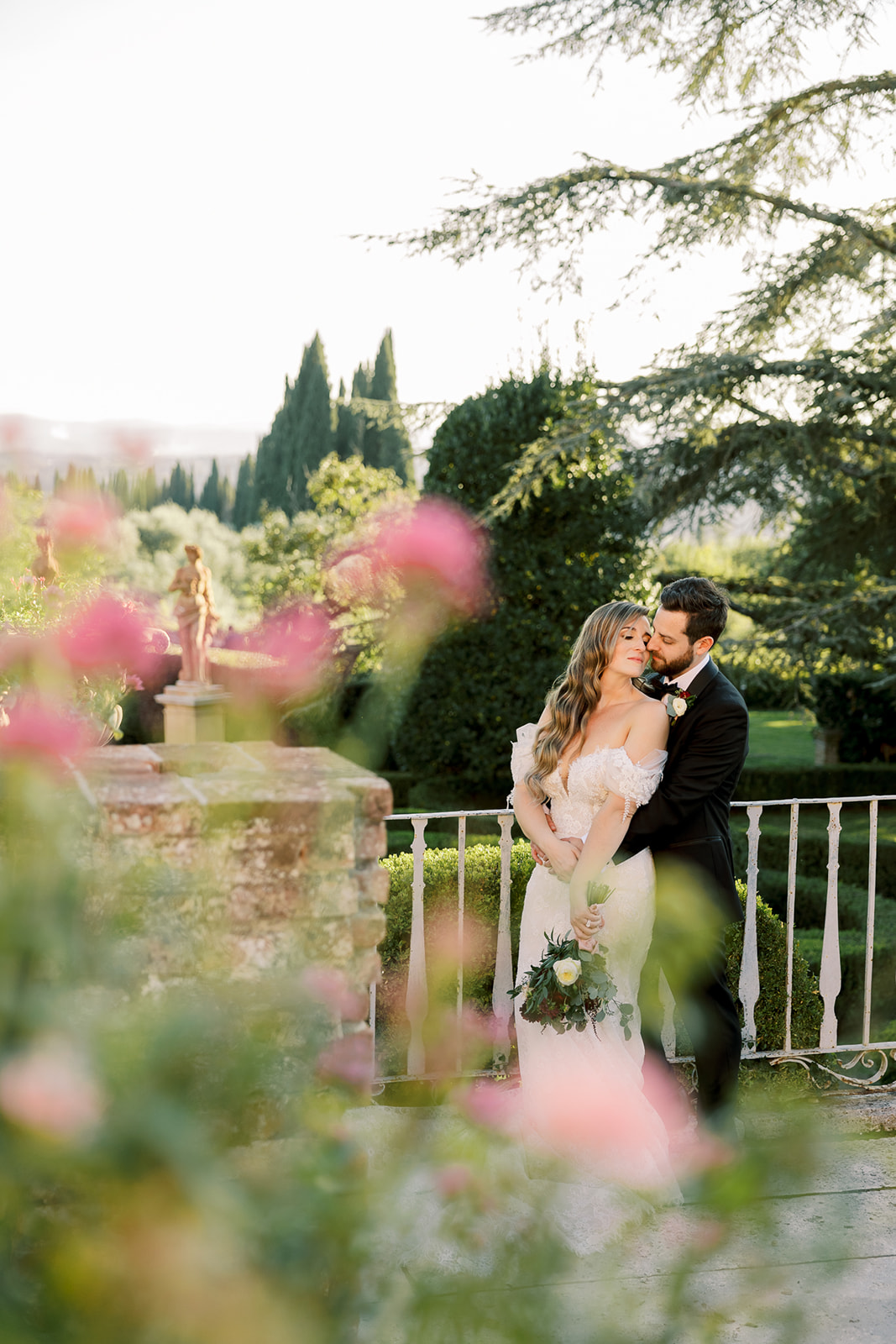bride and groom pose in the gardens at Villa Catignano
