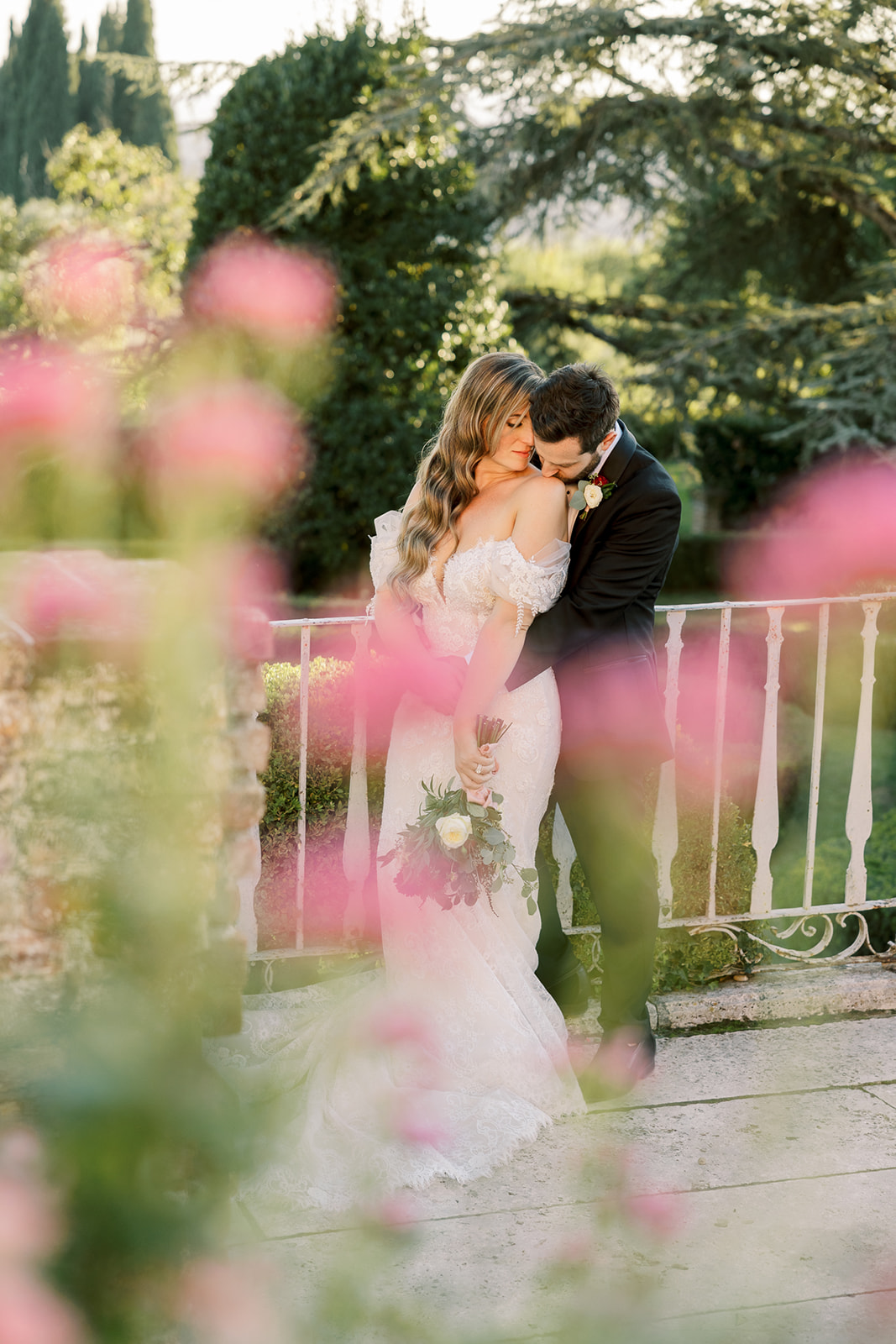 bride and groom pose in the gardens at Villa Catignano