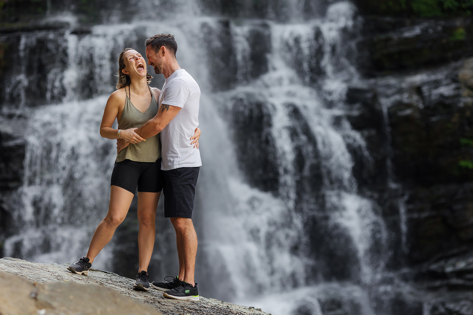 couple in front of waterfall