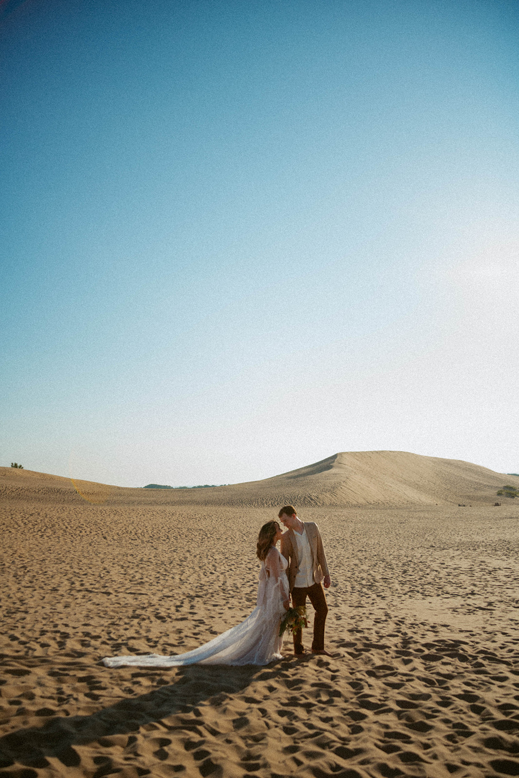 Couple gets bridal photos taken at Silver Lake Sand Dunes