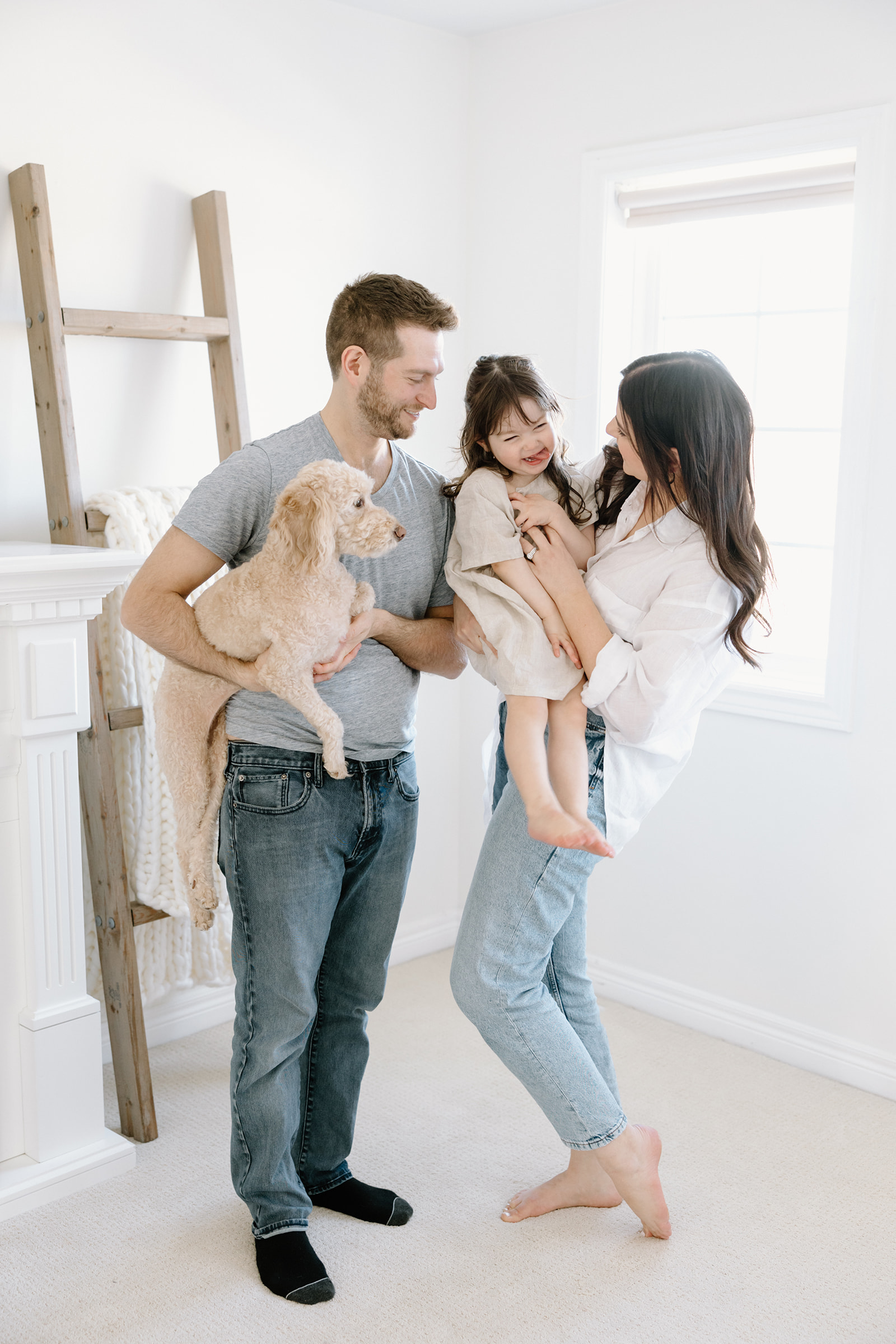 Family poses during at-home family photoshoot in Toronto, Ontario