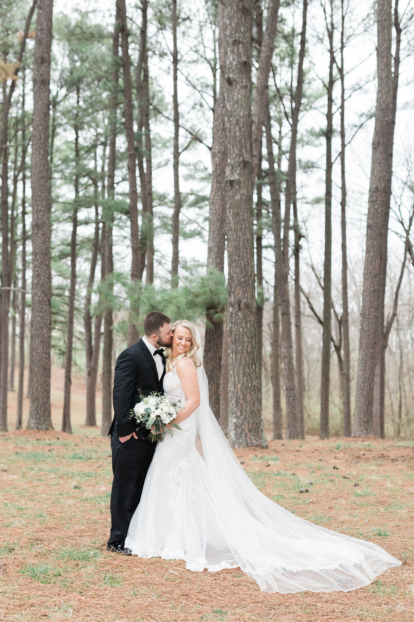 Bride and groom photos in pine trees in Waterloo, IL
