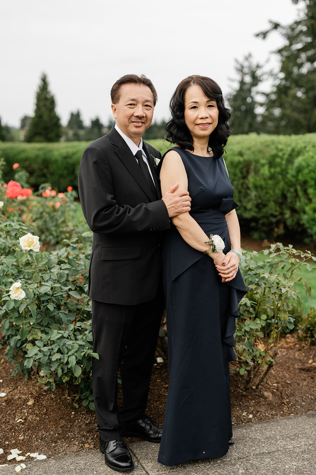 Bride's parents posing in the gardens of the Oregon Golf Club before the ceremony