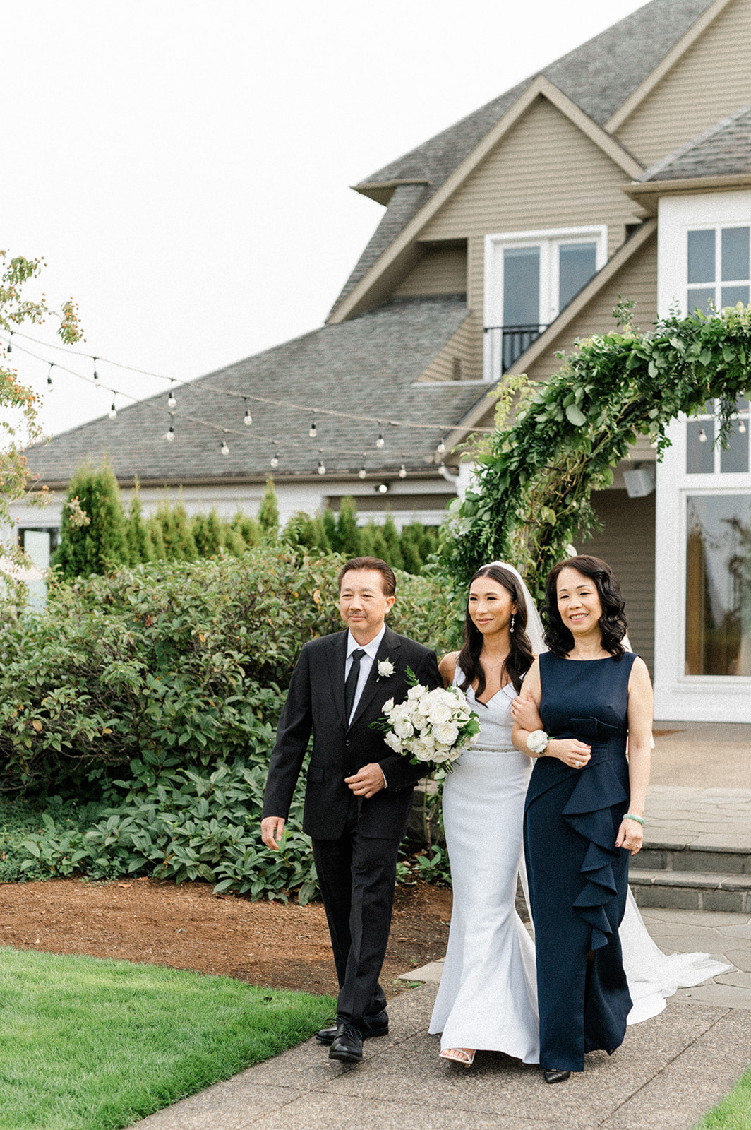 Bride's parents walk the bride down the aisle at her Oregon luxury wedding