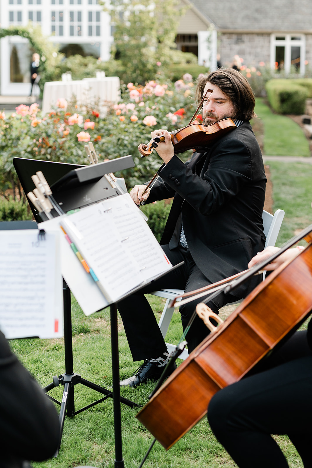 Live string quartet playing ceremony music on the lawn of a luxury Oregon wedding 