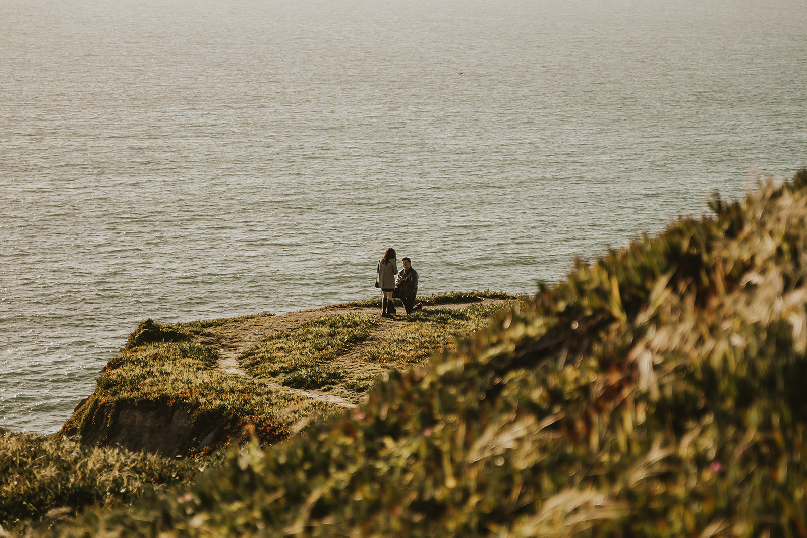 Man proposing to woman on the cliffs of Pacifica, California