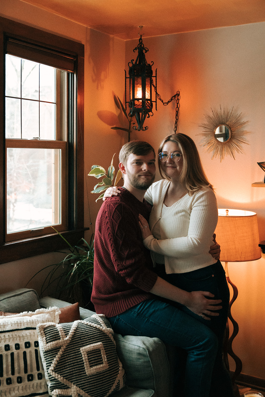Couple taking engagement pictures in a charming milwaukee airbnb
