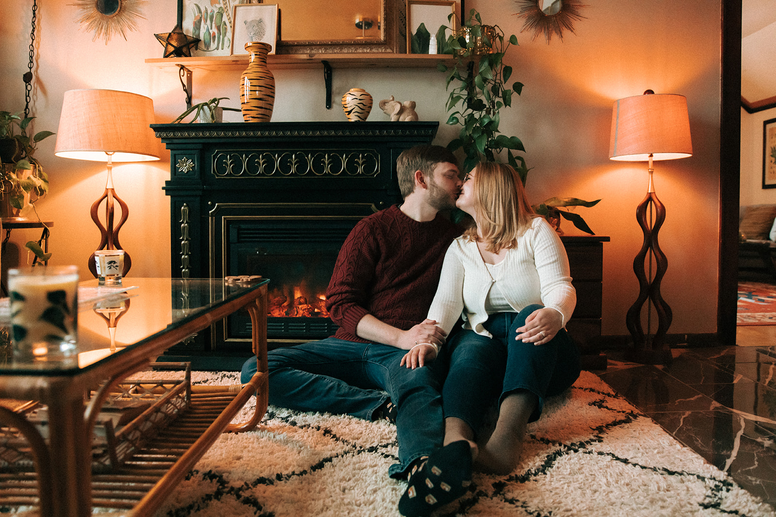 Couple taking engagement pictures in a cutemilwaukee airbnb with a fireplace
