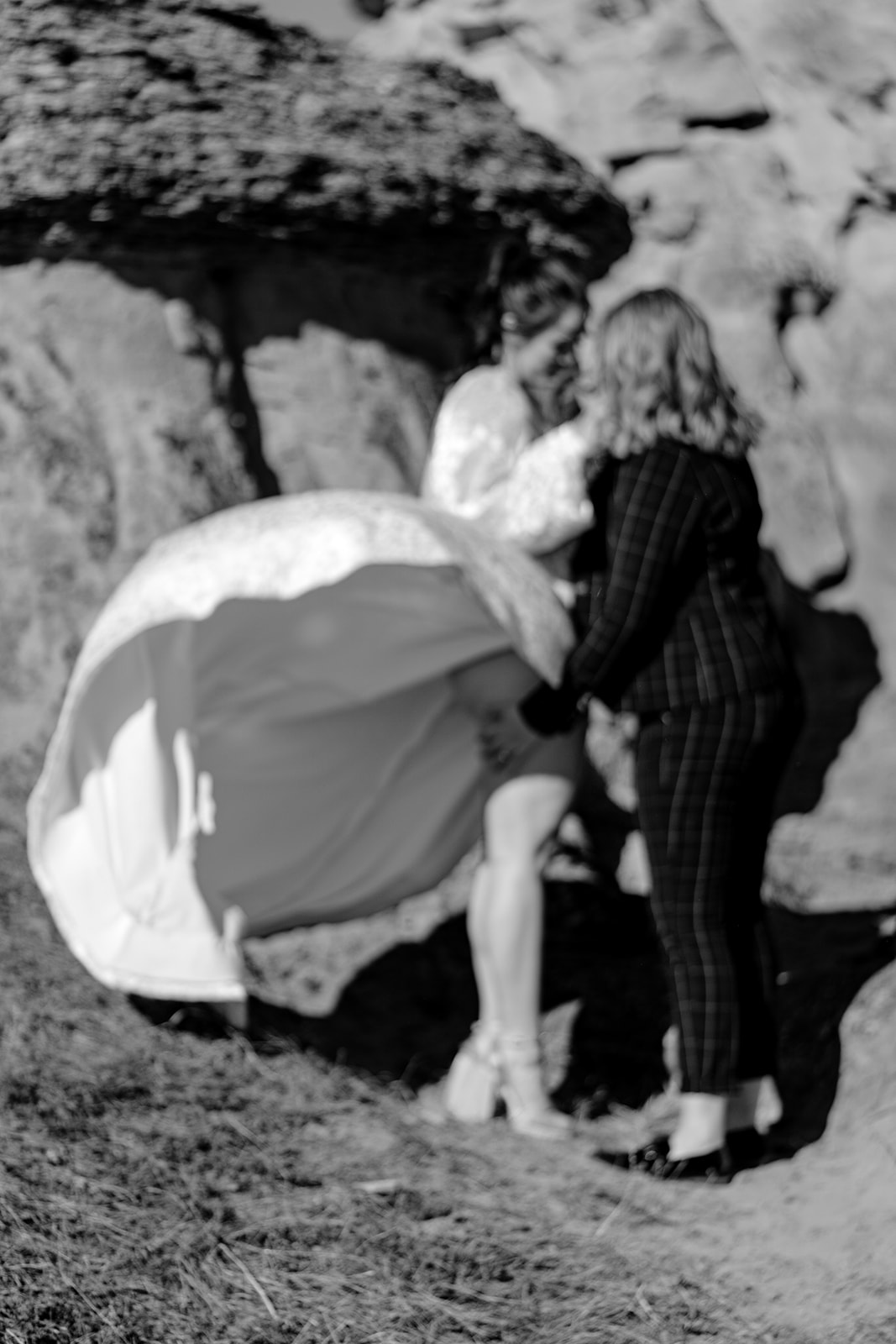 couple embraces in the wind after their southern alberta elopement at writing on stone provincial park