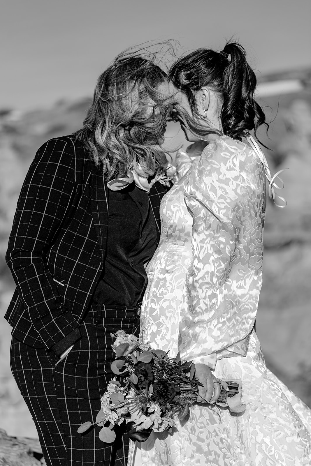 queer couple shares vows among the winds at writing on stone provincial park at their southern alberta elopement