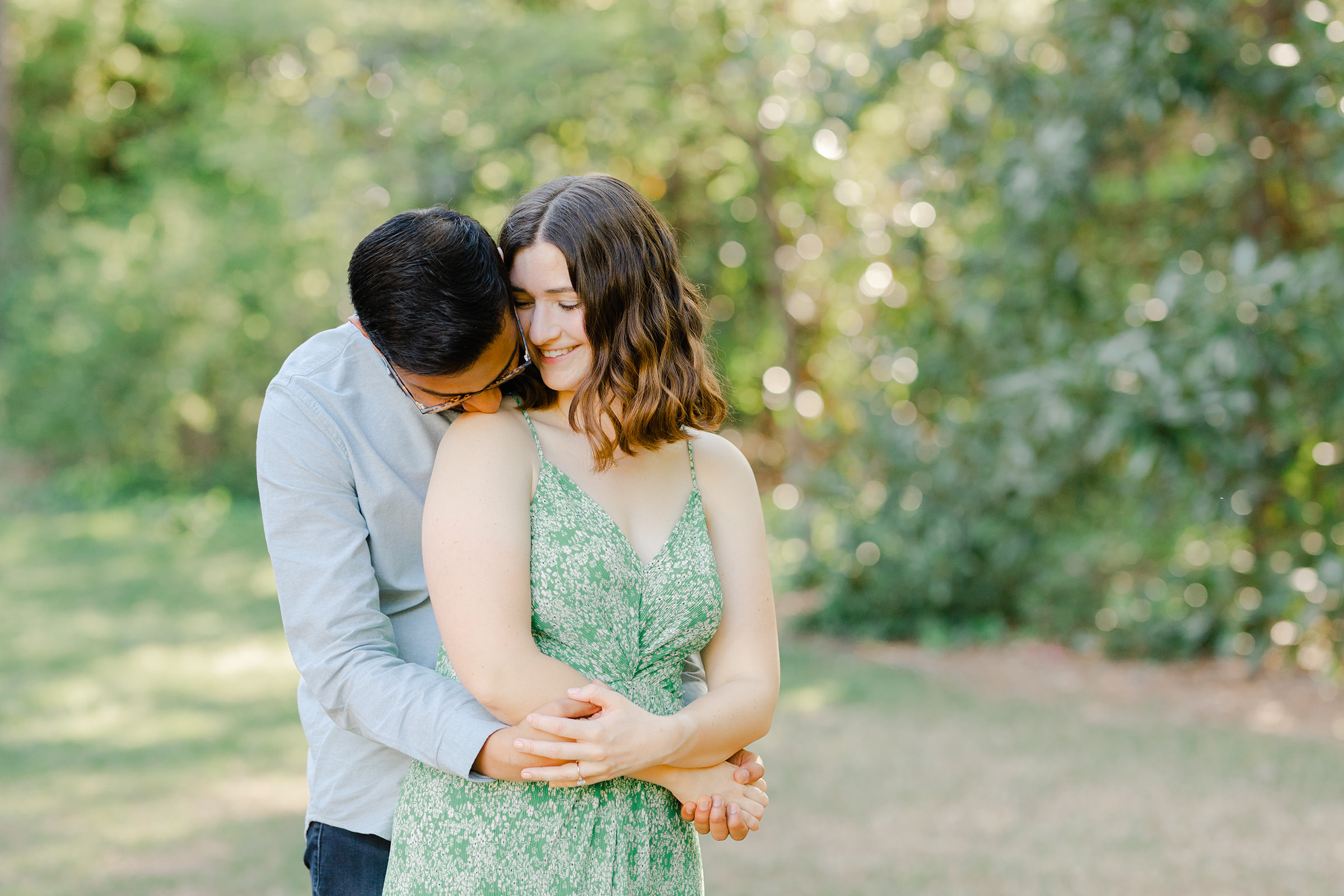 Couple hugging in the Raleigh Rose Garden for their engagement session