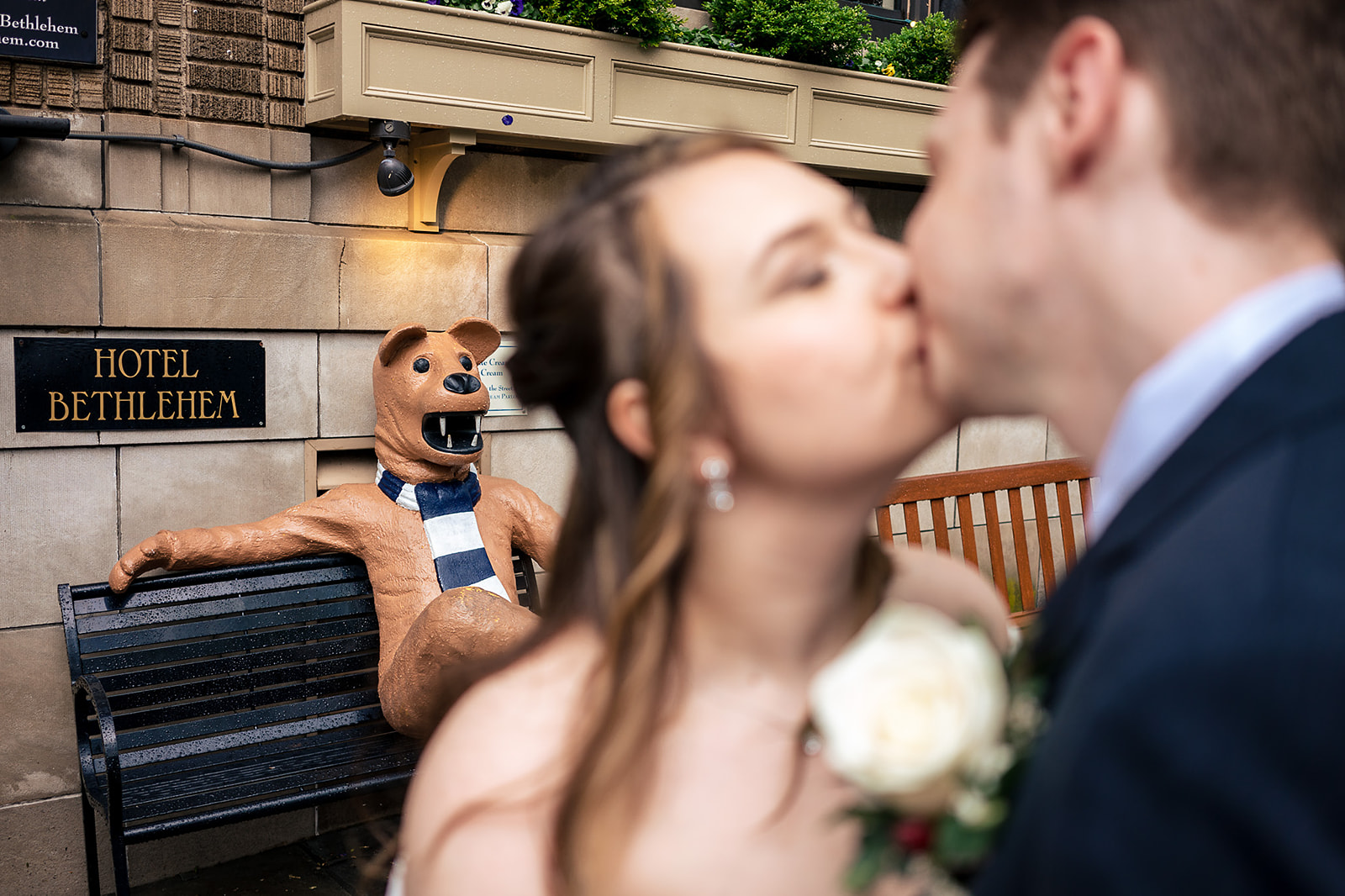 couple kissing in front of the penn state mascot at Hotel Bethlehem