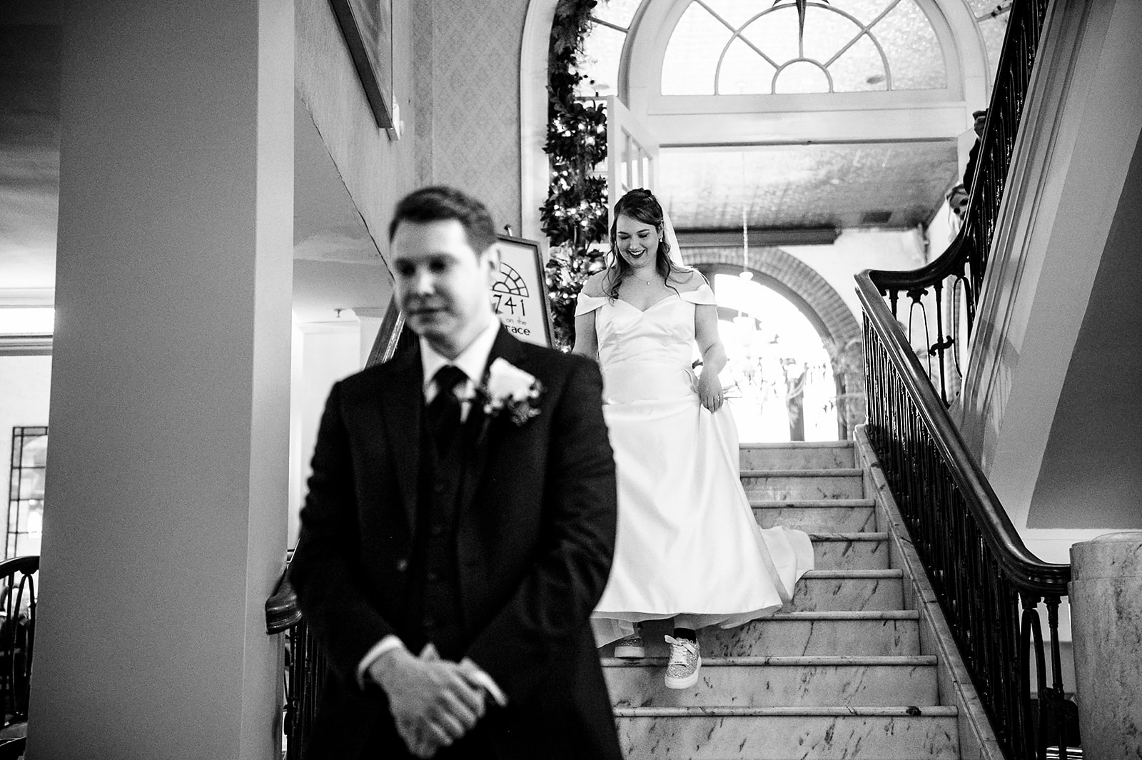 groom waiting as his bride walks down the stairs behind him Hotel Bethlehem