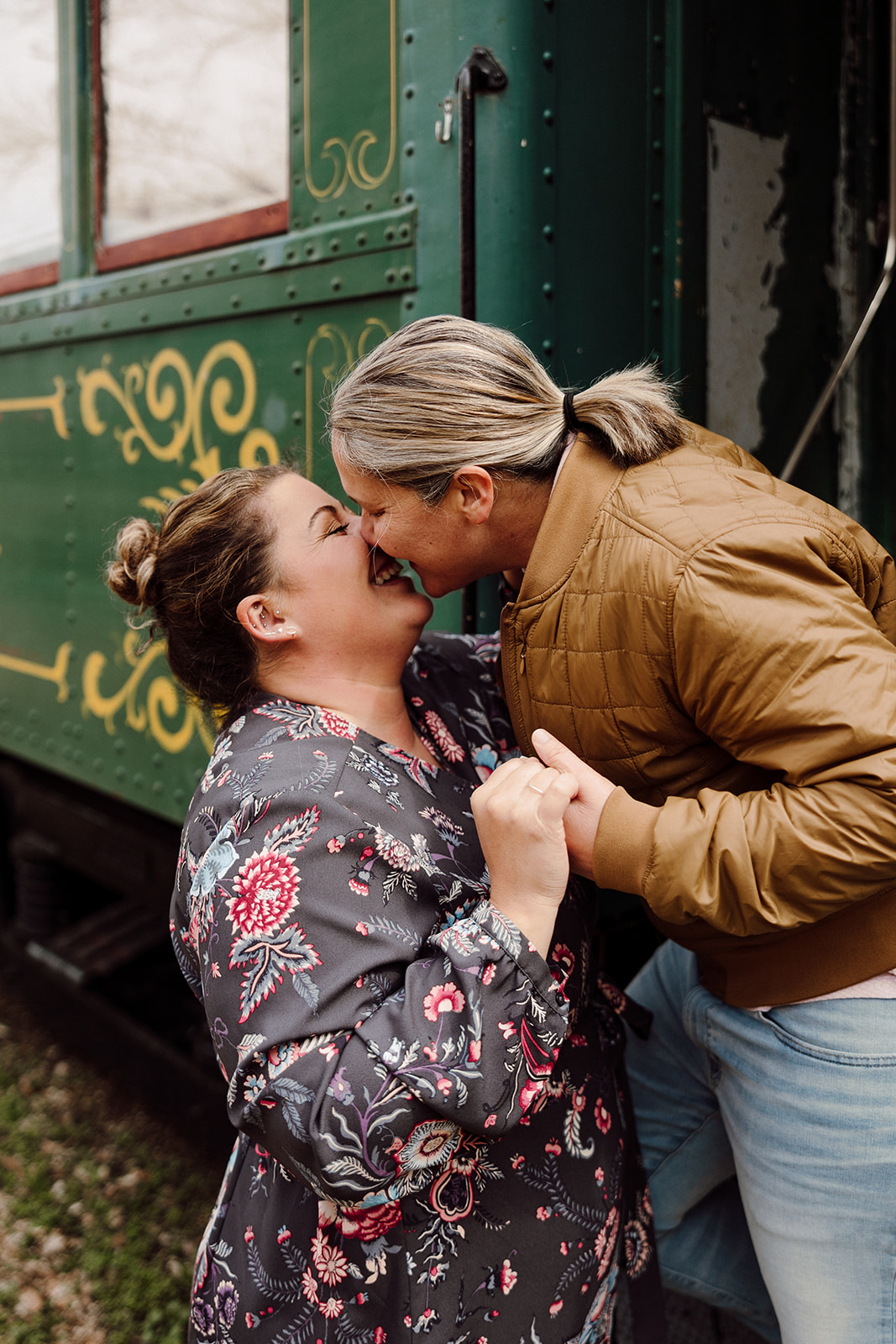 Women kissing for their city engagement session