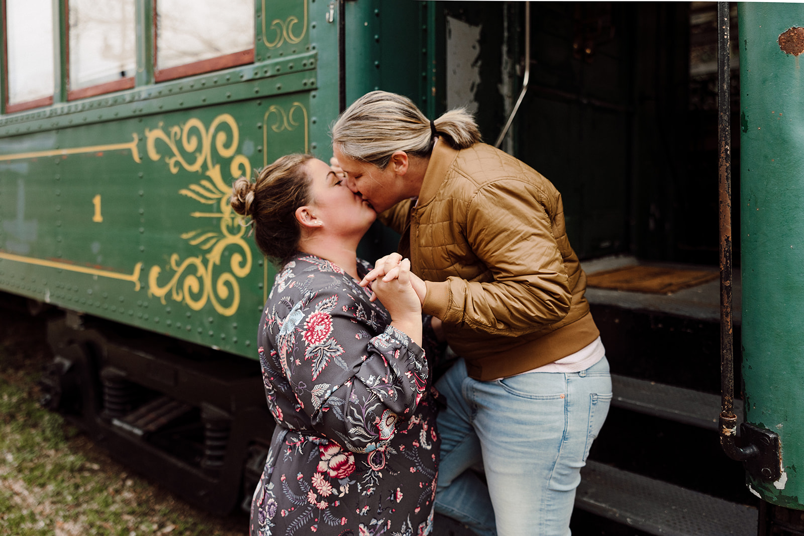 Women kissing for their city engagement session