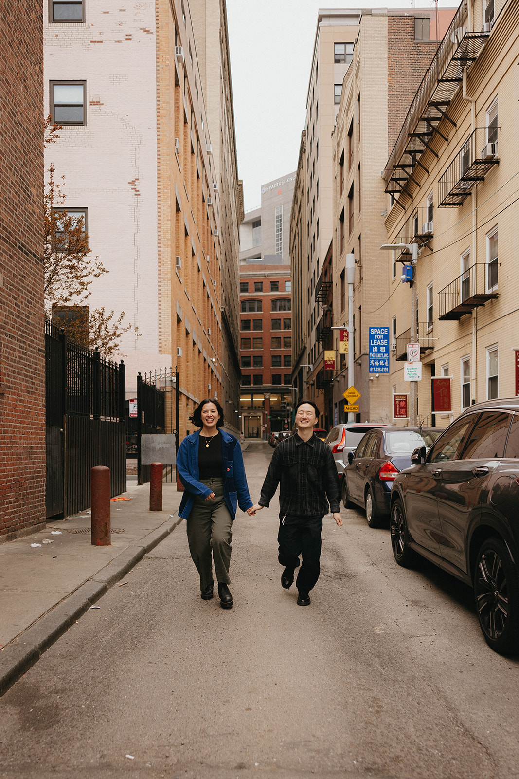 Julie and Soo Bin run through the streets of Chinatown for their engagement session in Boston