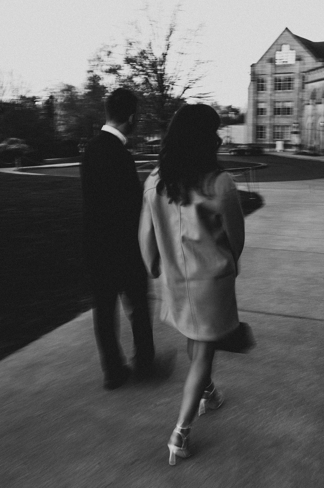 Documentary-style photo of couple walking hand-in-hand in Bishop's Garden.
