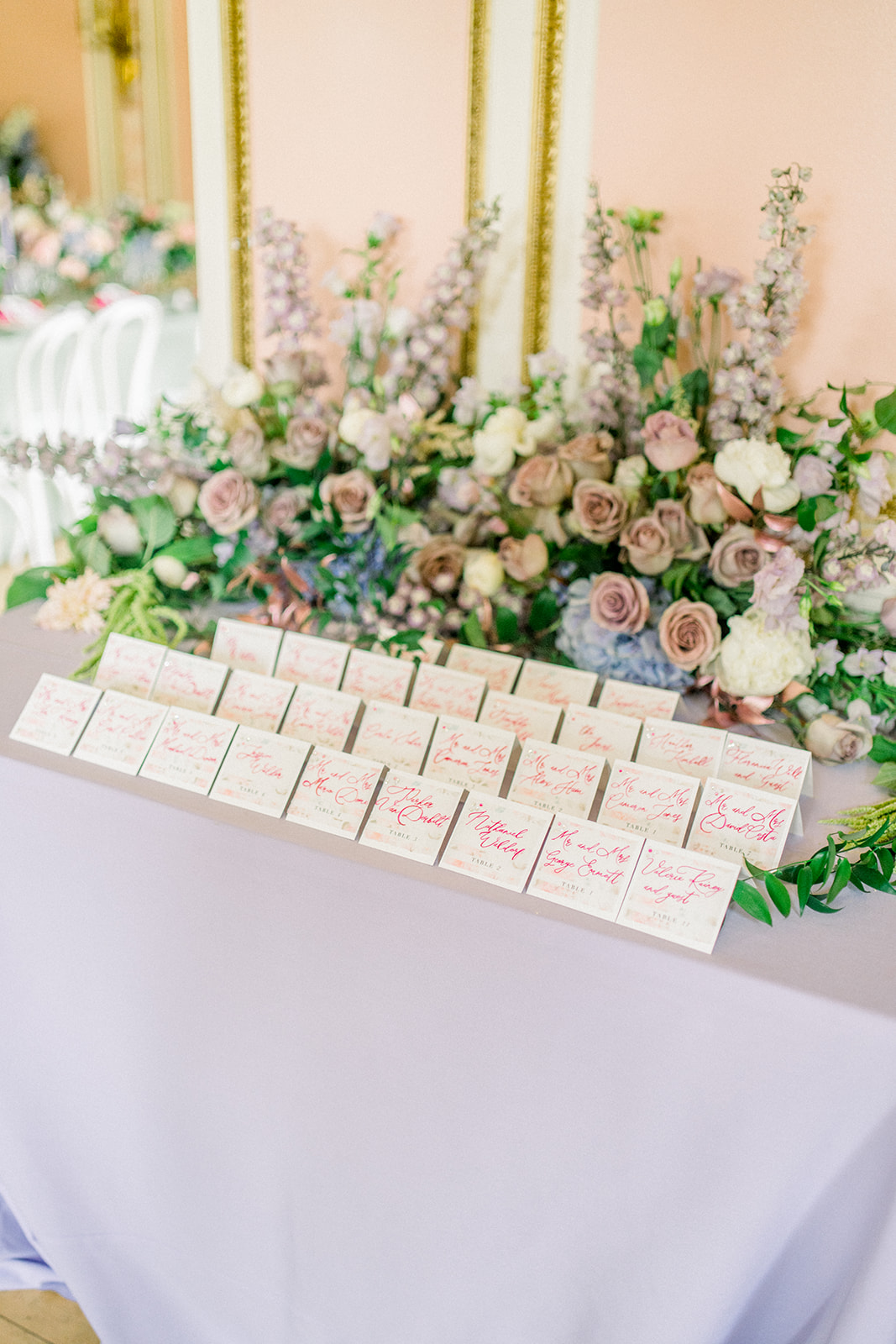 Custom wedding favor tags with calligraphy on a green silk ribbon, adding a personal touch to a luxury wedding
