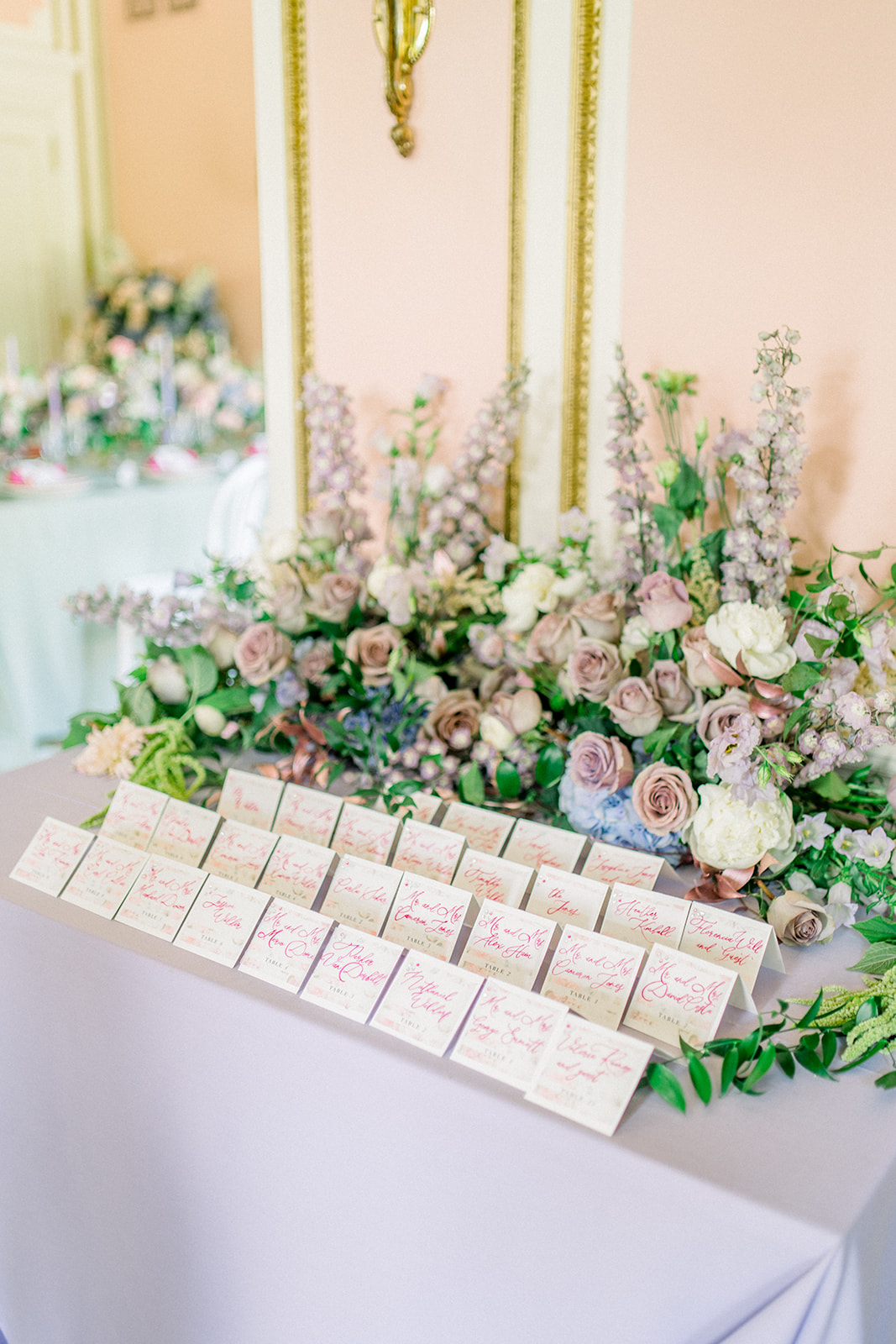 Custom wedding favor tags with calligraphy on a green silk ribbon, adding a personal touch to a luxury wedding