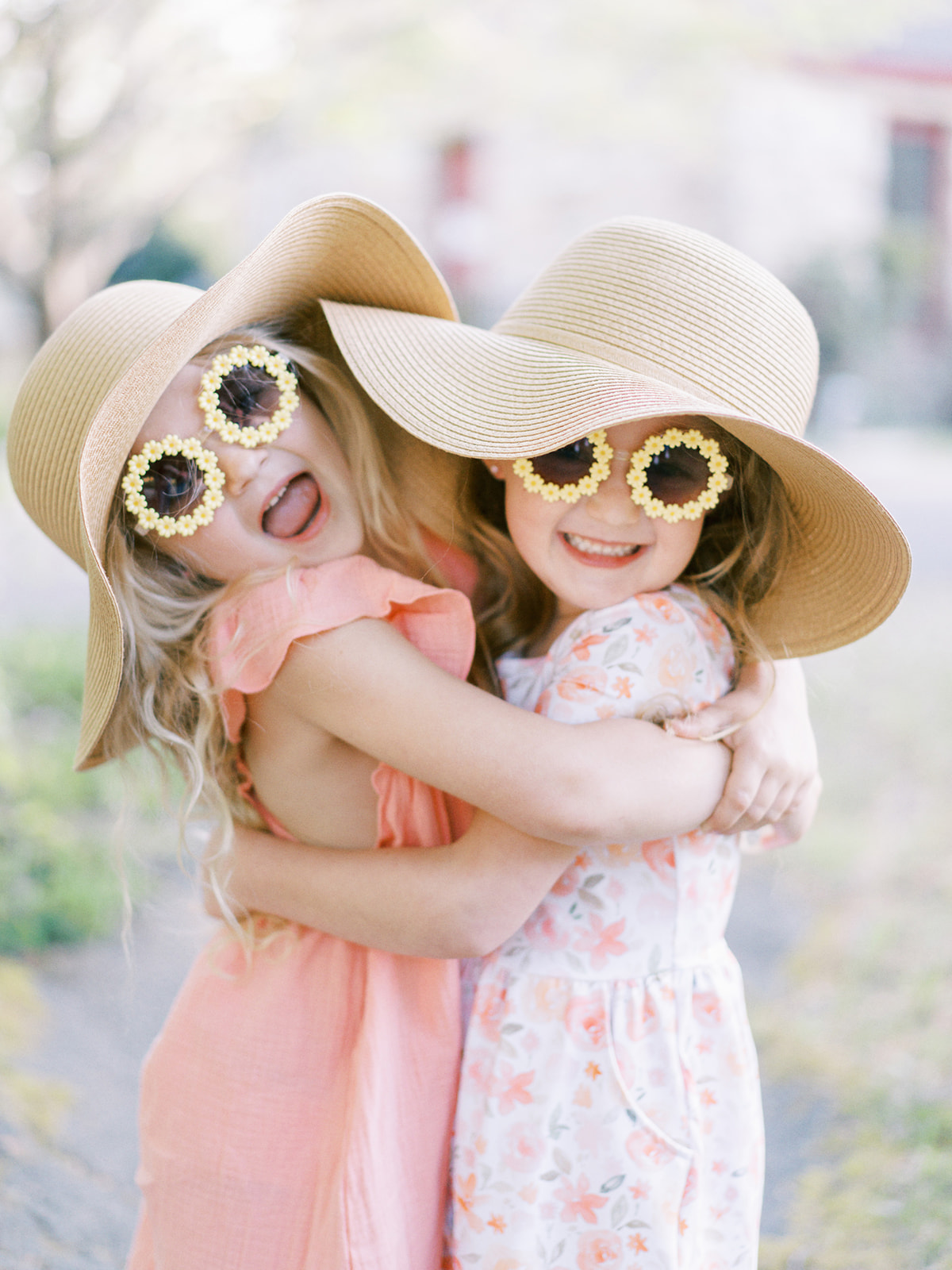 Two girls with sunglasses and hats pose at Sallie Howard Memorial Church in Mentone Alabama